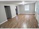 Bright living room with wood-look flooring, neutral walls, and natural light from windows at 309 S Fleming St, Indianapolis, IN 46241