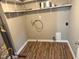 Utility room with wood-look flooring, and open shelving for ample storage at 309 S Fleming St, Indianapolis, IN 46241
