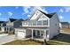 Two-story home with gray siding, white trim, and a two-car garage at 230 Mcnair Rd, Whiteland, IN 46184