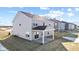 Two-story home with gray siding, covered patio, and backyard at 230 Mcnair Rd, Whiteland, IN 46184