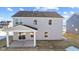 Two-story home with gray siding, covered patio, and backyard at 230 Mcnair Rd, Whiteland, IN 46184