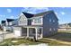 Two-story gray house with white accents, stone facade, and a covered porch at 250 Mcnair Rd, Whiteland, IN 46184