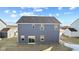 Rear view of a two-story gray house showcasing its sliding glass doors and backyard at 250 Mcnair Rd, Whiteland, IN 46184