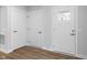 Bright entry hall with three white doors and wood-look flooring at 420 Charles Freer Ln, Whiteland, IN 46184
