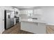 White kitchen with stainless steel appliances and quartz countertops at 420 Charles Freer Ln, Whiteland, IN 46184