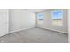Bright bedroom featuring gray carpeting and large windows at 432 Charles Freer Ln, Whiteland, IN 46184