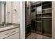 Walk-in closet with storage shelves and drawers near vanity with sink and mirror at 504 N Park N Ave # 4, Indianapolis, IN 46202