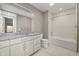 Bathroom featuring granite countertops, a large mirror, and a shower/tub combo at 504 N Park N Ave # 4, Indianapolis, IN 46202