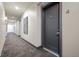 Hallway featuring carpet, wall art, sconce lighting, and a unit number, offering an inviting space at 504 N Park N Ave # 4, Indianapolis, IN 46202