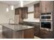 Modern kitchen featuring stainless steel appliances, dark wood cabinetry and an island with sink at 504 N Park N Ave # 4, Indianapolis, IN 46202
