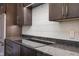 Modern kitchen featuring stainless steel appliances and sleek dark cabinetry at 504 N Park N Ave # 4, Indianapolis, IN 46202