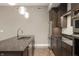 Sleek kitchen with stainless steel appliances, granite countertops, and dark wood cabinets at 504 N Park N Ave # 4, Indianapolis, IN 46202