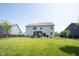 Wide view of backyard, showing lawn, back of home, and patio area with pergola at 5573 Mahogany Dr, Noblesville, IN 46062