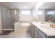 Bathroom features a walk-in shower, soaking tub, double vanity with gold fixtures and tile flooring at 5573 Mahogany Dr, Noblesville, IN 46062