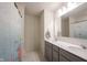 Bathroom featuring double vanity, large mirror, and shower with playful fish themed curtain at 5573 Mahogany Dr, Noblesville, IN 46062