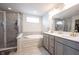 Bathroom features a walk-in shower, soaking tub, double vanity with gold fixtures and tile flooring at 5573 Mahogany Dr, Noblesville, IN 46062