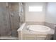Bathroom features a walk-in shower and separate soaking tub with tile flooring and white walls at 5573 Mahogany Dr, Noblesville, IN 46062