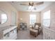 Bedroom featuring a white crib, changing table, floral decor and a comfortable armchair at 5573 Mahogany Dr, Noblesville, IN 46062