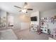 Playroom and landing area features a daybed, play kitchen, book shelves, and television at 5573 Mahogany Dr, Noblesville, IN 46062