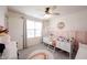 Bright bedroom with stylish bed, pink walls, and neutral decor at 5573 Mahogany Dr, Noblesville, IN 46062