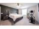 Inviting main bedroom features a ceiling fan, an exercise bike, and a large window at 5573 Mahogany Dr, Noblesville, IN 46062