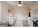 Bedroom with a white crib, changing table and daisy-themed decor creating a cheerful and welcoming space at 5573 Mahogany Dr, Noblesville, IN 46062