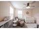 Bedroom showcasing a cozy armchair, crib, and soft decor creating a peaceful ambiance at 5573 Mahogany Dr, Noblesville, IN 46062
