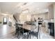 Open concept dining area with wood table, chairs and pendant lighting adjacent to the kitchen at 5573 Mahogany Dr, Noblesville, IN 46062