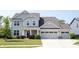 Charming two-story home with a three car garage and a well-maintained lawn at 5573 Mahogany Dr, Noblesville, IN 46062