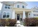 Inviting front entrance with a black door, decorative columns and manicured landscaping at 5573 Mahogany Dr, Noblesville, IN 46062