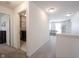 Bright hallway featuring carpet, white walls, recessed lighting, and leading to laundry and living area at 5573 Mahogany Dr, Noblesville, IN 46062