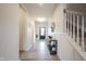 Bright hallway featuring hardwood floors, white trim, and staircase with decor at 5573 Mahogany Dr, Noblesville, IN 46062