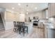 Bright kitchen features stainless appliances, gray cabinets, granite countertops, and pendant lighting at 5573 Mahogany Dr, Noblesville, IN 46062
