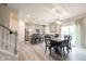 Open concept living area with dining area, stairs, and sliding door to the outside at 5573 Mahogany Dr, Noblesville, IN 46062