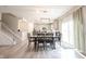 Open concept living area with dining area, stairs, and sliding door to the outside at 5573 Mahogany Dr, Noblesville, IN 46062