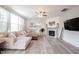 Cozy living room with a fireplace, comfortable sectional sofa and wood floors at 5573 Mahogany Dr, Noblesville, IN 46062