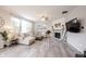 Bright living room with a fireplace, comfortable sectional sofa and wood floors at 5573 Mahogany Dr, Noblesville, IN 46062