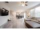 Open-concept living room with hardwood floors and ample natural light from large windows at 5573 Mahogany Dr, Noblesville, IN 46062
