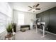 Bright office features stylish accent wall, modern furnishings, and plenty of natural light from a large window at 5573 Mahogany Dr, Noblesville, IN 46062