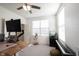 Bright home office features a wooden desk, a keyboard, and ample natural light at 5573 Mahogany Dr, Noblesville, IN 46062