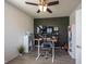 A modern home office with a height-adjustable desk, stylish green accent wall, and sleek storage solutions at 5573 Mahogany Dr, Noblesville, IN 46062