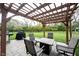 Outdoor patio featuring a pergola with string lights, outdoor seating, and a grill at 5573 Mahogany Dr, Noblesville, IN 46062