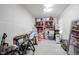 Brightly lit storage room featuring organized shelving, various storage containers, and a bicycle at 5573 Mahogany Dr, Noblesville, IN 46062