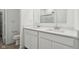 Bright bathroom featuring double sinks, modern fixtures, quartz countertops, and a large mirror at 10008 Sundley Dr, Indianapolis, IN 46239