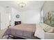 Bright bedroom features a metal bed frame, television, carpet flooring, and modern lighting fixture at 10008 Sundley Dr, Indianapolis, IN 46239