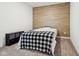 Cozy bedroom features wood-look accent wall at 10008 Sundley Dr, Indianapolis, IN 46239