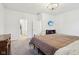 Bright bedroom with a metal bed frame, TV, and adjoining bathroom access, offering comfort and convenience at 10008 Sundley Dr, Indianapolis, IN 46239