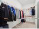 Spacious walk-in closet featuring plenty of storage space with metal racks and carpet flooring at 10008 Sundley Dr, Indianapolis, IN 46239