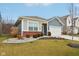Charming single-story home with blue siding, brick accents, a two-car garage, and a well-manicured front yard at 10008 Sundley Dr, Indianapolis, IN 46239