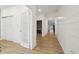 Light-filled hallway with plank flooring, white shiplap accent wall, and multiple doors providing access to rooms at 10008 Sundley Dr, Indianapolis, IN 46239